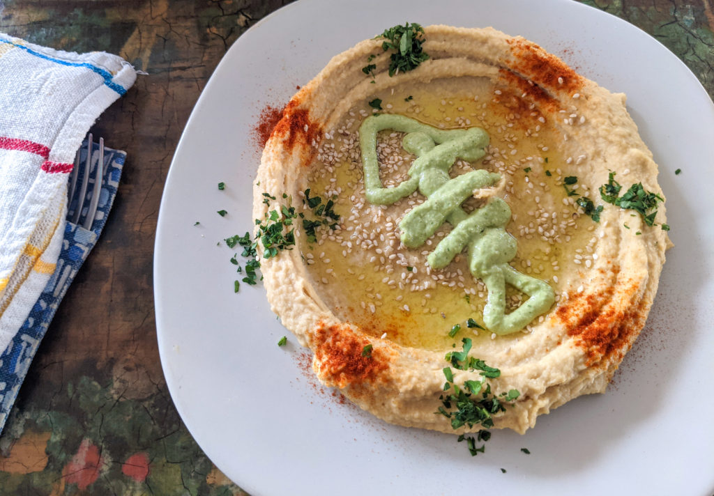 Hummus with sauce and spices in one of the best restaurants in Puerto Escondido